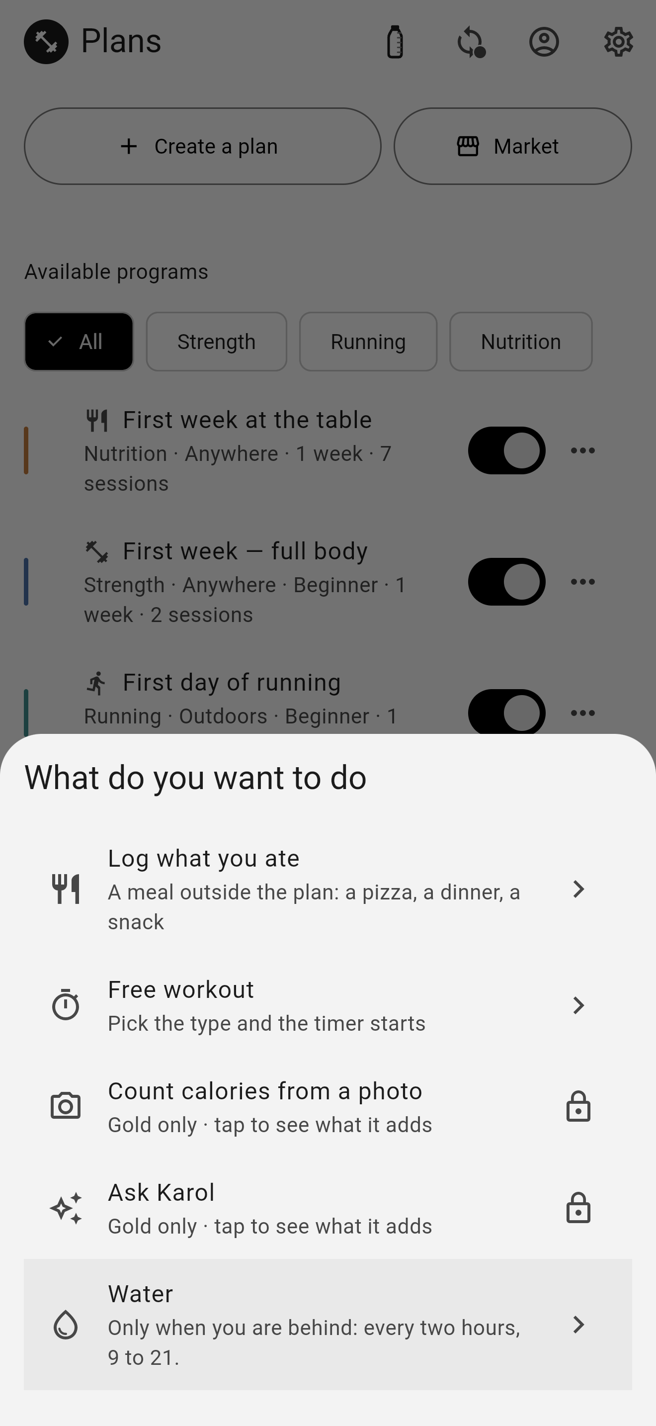 The «What do you want to do» sheet open over the plans: log what you ate, free workout, count calories from a photo and ask Karol — the last two with a padlock and the line «Gold only» — and water at the bottom.